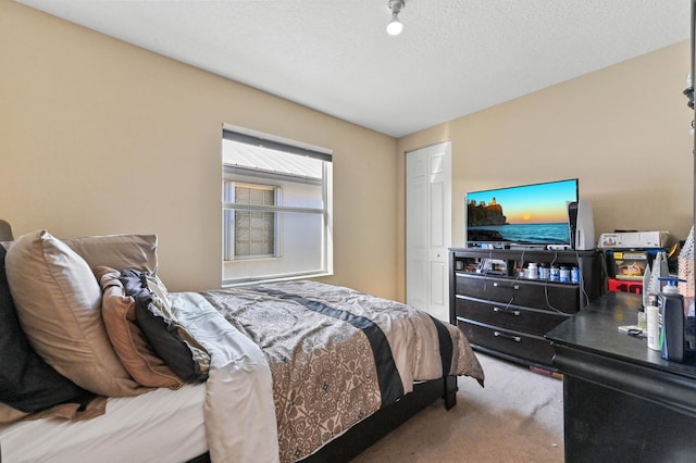 carpeted bedroom with a textured ceiling