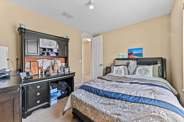 carpeted bedroom with a textured ceiling