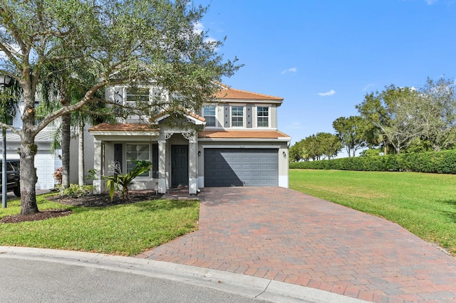 view of front of property with a front yard and a garage