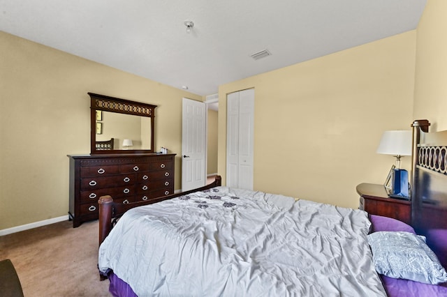 bedroom with light colored carpet and a closet