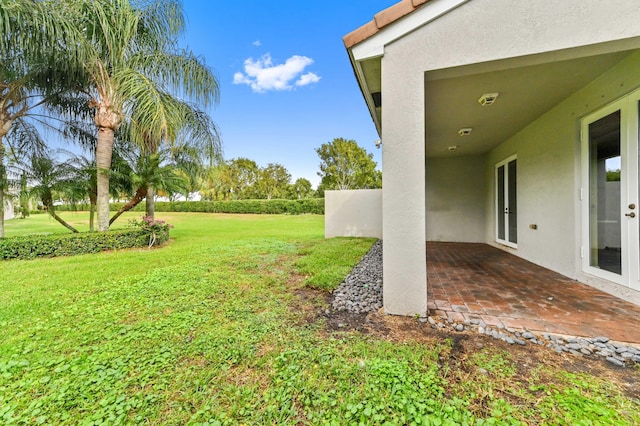 view of yard featuring a patio and french doors