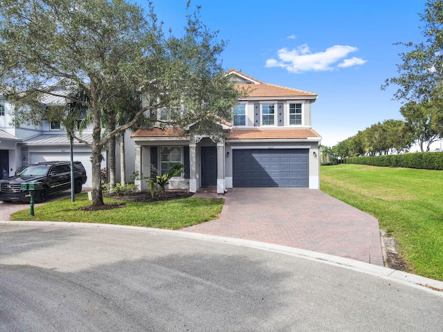 view of front of property featuring a front yard and a garage