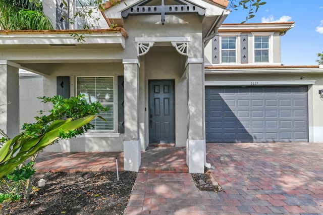 view of exterior entry with a garage