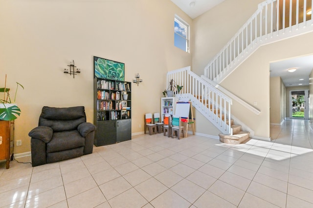 interior space with light tile patterned floors and a high ceiling