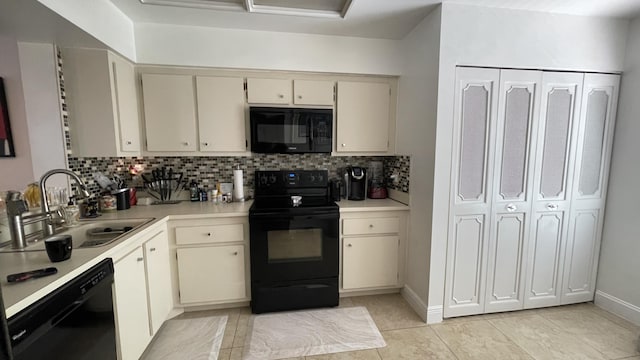 kitchen with backsplash, sink, black appliances, and cream cabinetry