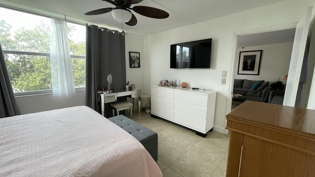 tiled bedroom with multiple windows and ceiling fan