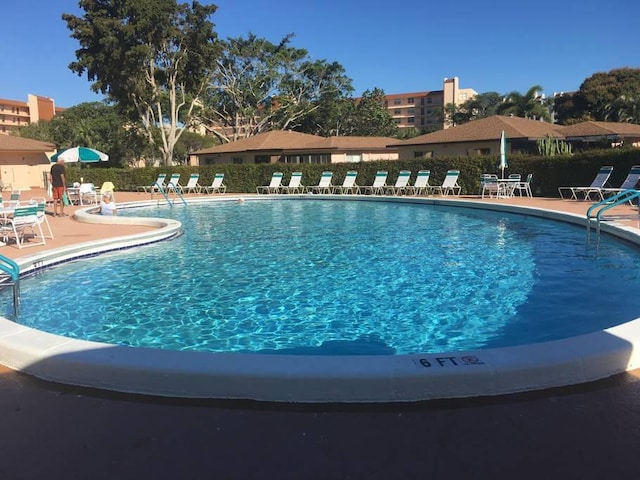 view of swimming pool with a patio area