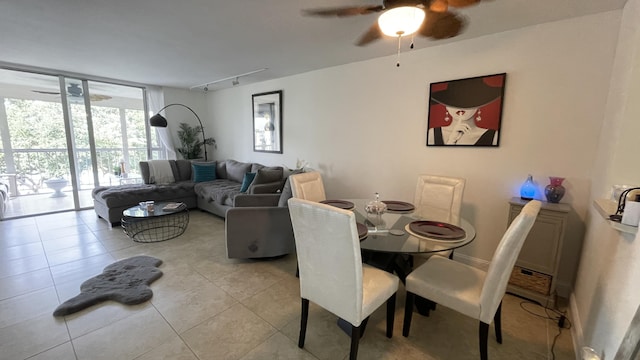 dining space with ceiling fan, floor to ceiling windows, light tile patterned floors, and rail lighting