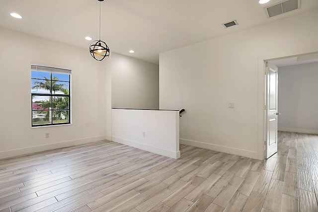 unfurnished room featuring light hardwood / wood-style floors