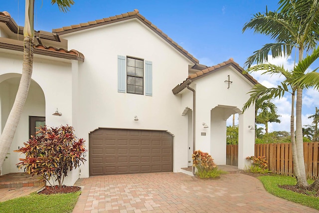 mediterranean / spanish house with a garage