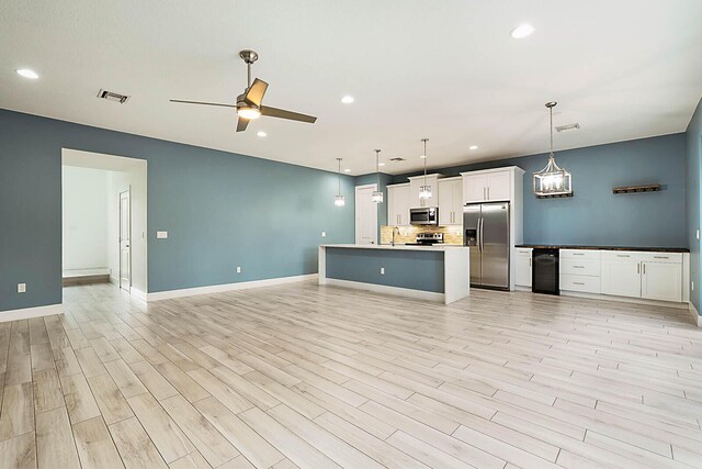 kitchen with white cabinets, appliances with stainless steel finishes, decorative backsplash, hanging light fixtures, and ceiling fan