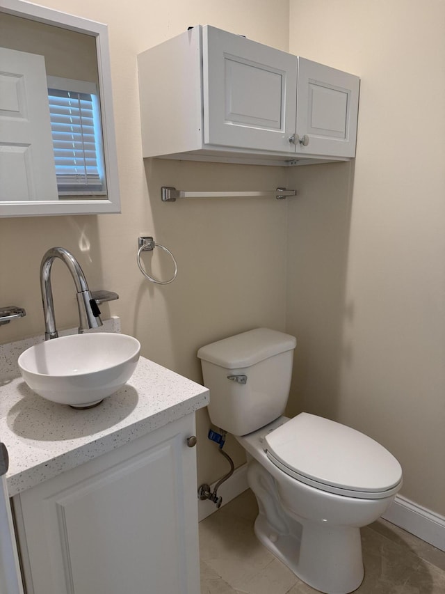 bathroom featuring tile patterned flooring, vanity, and toilet