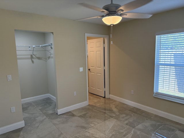 unfurnished bedroom featuring ceiling fan and a closet