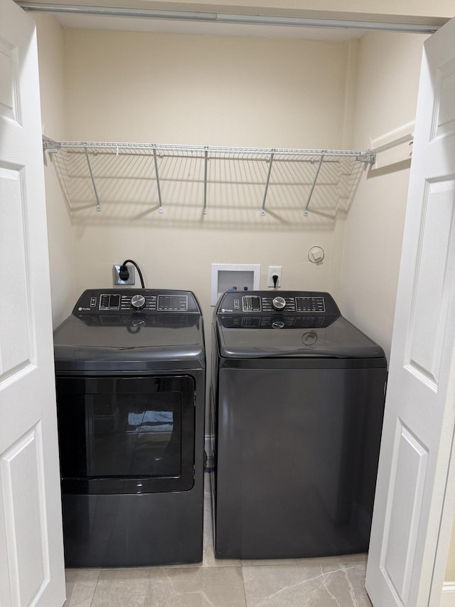 washroom featuring washing machine and dryer