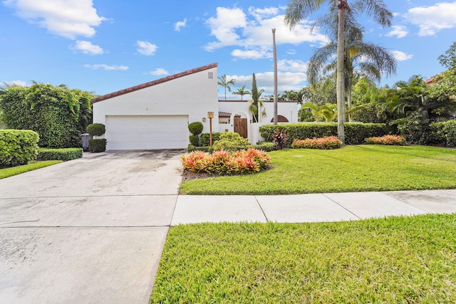 view of front of home with a front yard and a garage