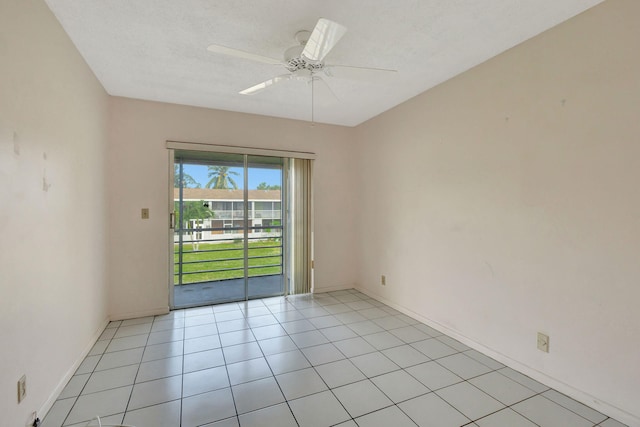 tiled spare room with ceiling fan