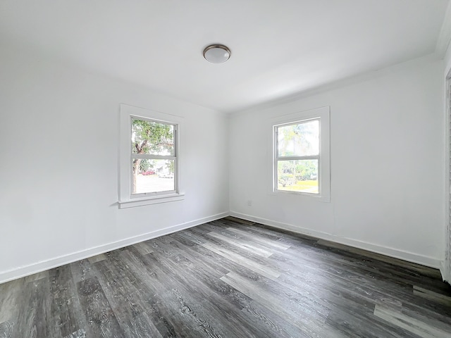 empty room with dark wood-type flooring