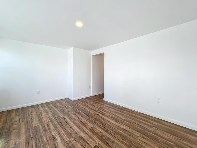 empty room with dark wood-type flooring