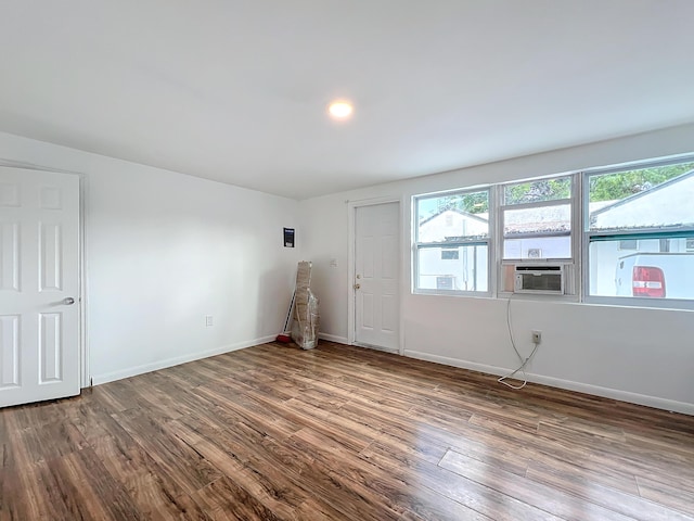 spare room featuring cooling unit and wood-type flooring