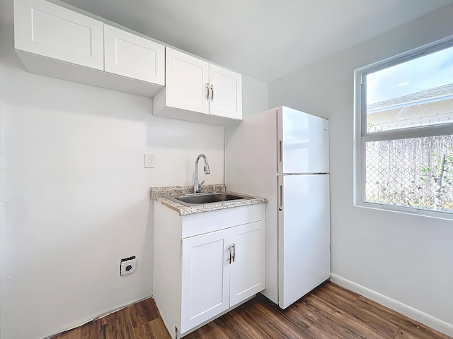 kitchen featuring white fridge, sink, white cabinets, and dark wood-type flooring