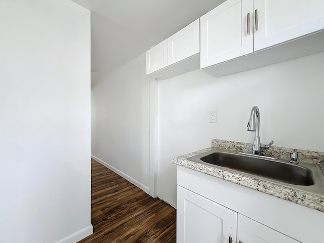 kitchen featuring sink, white cabinets, and dark hardwood / wood-style floors