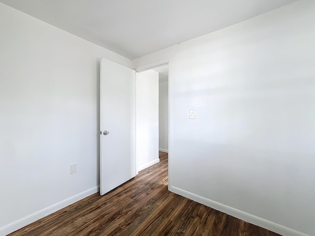 empty room with dark hardwood / wood-style floors