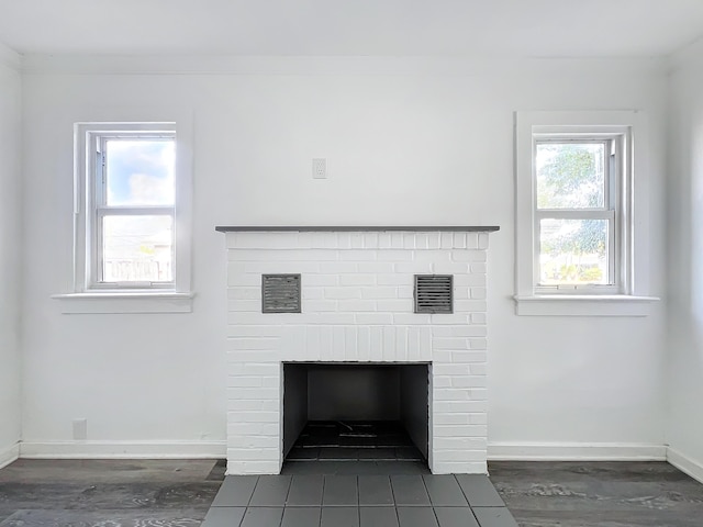 interior details with crown molding and a brick fireplace