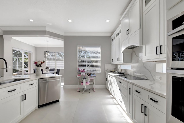 kitchen with pendant lighting, sink, white cabinetry, and stainless steel appliances