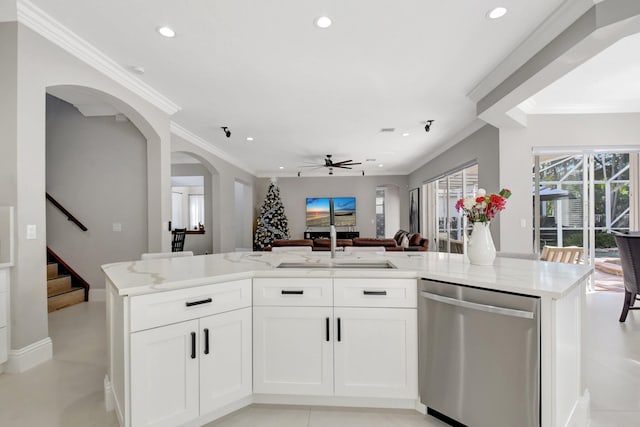 kitchen with light stone countertops, stainless steel dishwasher, ceiling fan, a kitchen island with sink, and white cabinets