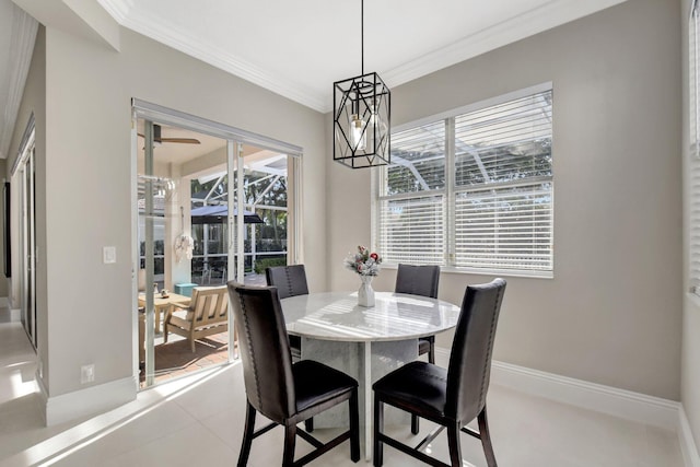 tiled dining space featuring plenty of natural light, a notable chandelier, and ornamental molding