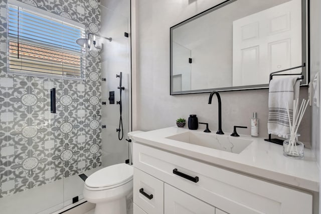 bathroom featuring vanity, a shower with shower door, a baseboard heating unit, and toilet