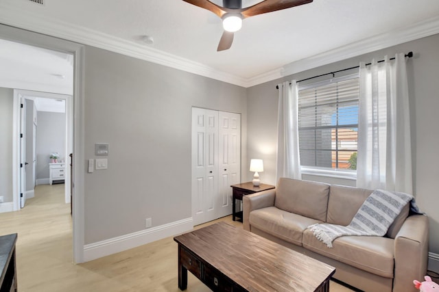 living room with ceiling fan, light hardwood / wood-style floors, and ornamental molding