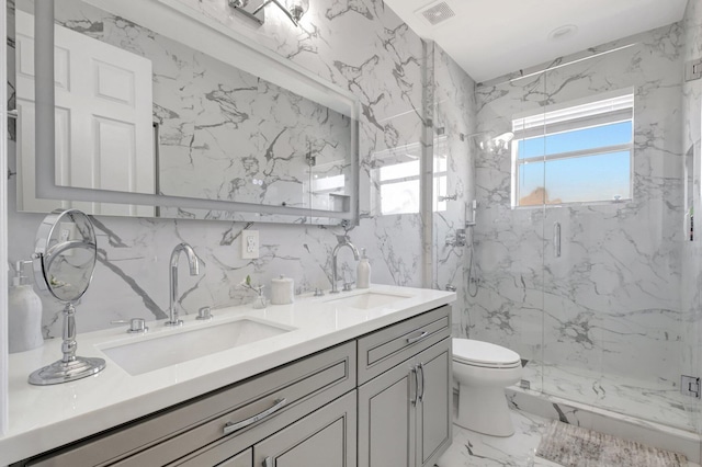 bathroom featuring a shower with door, vanity, and toilet