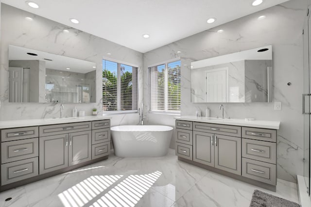 bathroom featuring separate shower and tub, vanity, and tile walls