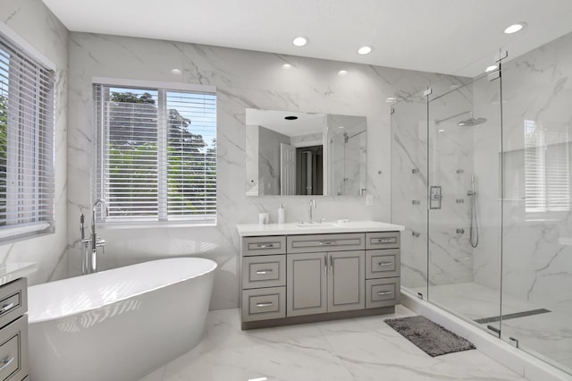 bathroom with vanity and shower with separate bathtub