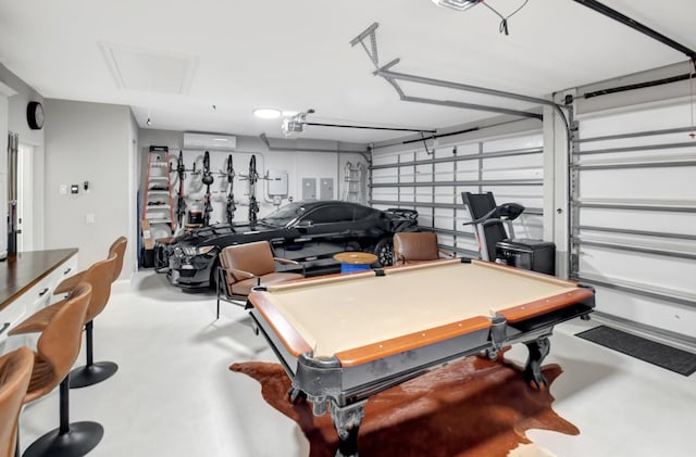 game room with a wall unit AC, concrete flooring, and billiards