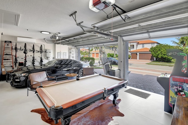 rec room featuring a wall mounted AC, a textured ceiling, and pool table