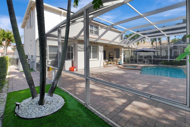 view of pool featuring an in ground hot tub, a patio, and a lanai