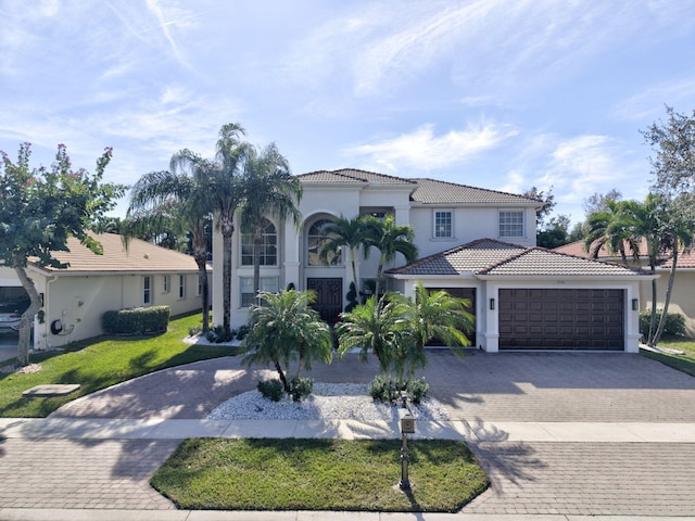 mediterranean / spanish-style home with a front yard