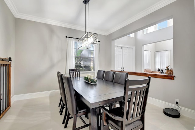 dining area with a barn door and crown molding