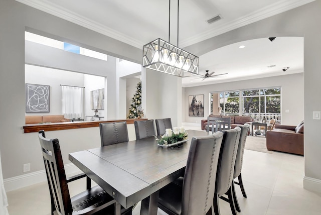 dining space with ceiling fan, ornamental molding, and light tile patterned flooring