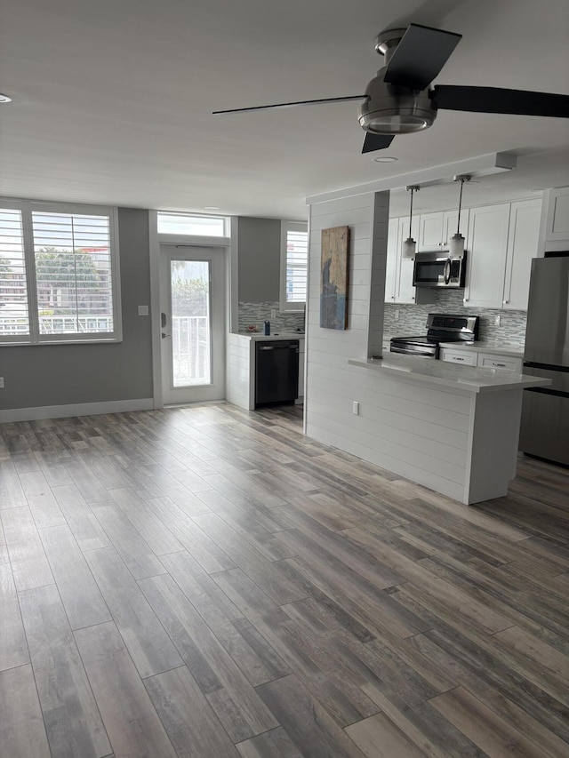 kitchen featuring hardwood / wood-style floors, stainless steel appliances, white cabinetry, and ceiling fan