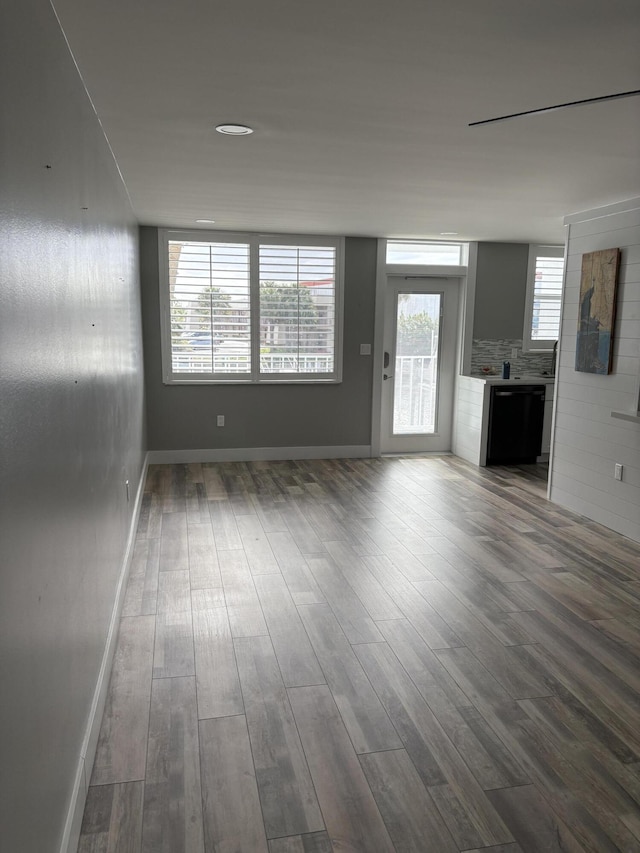 unfurnished living room with dark hardwood / wood-style flooring