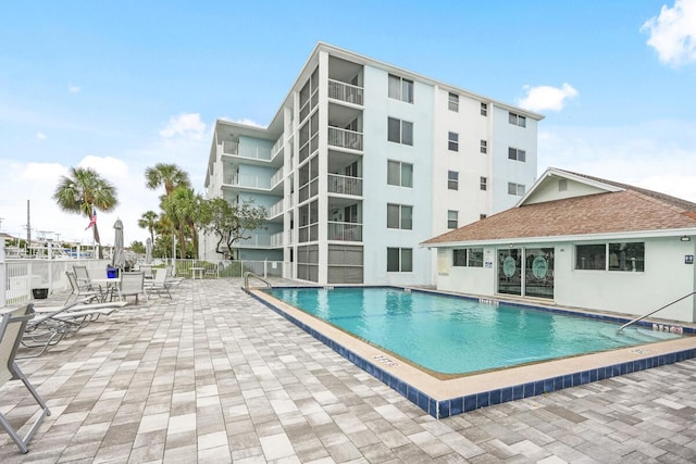 community pool featuring a patio area and fence