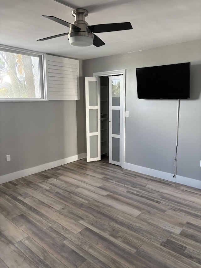 spare room featuring hardwood / wood-style flooring and ceiling fan