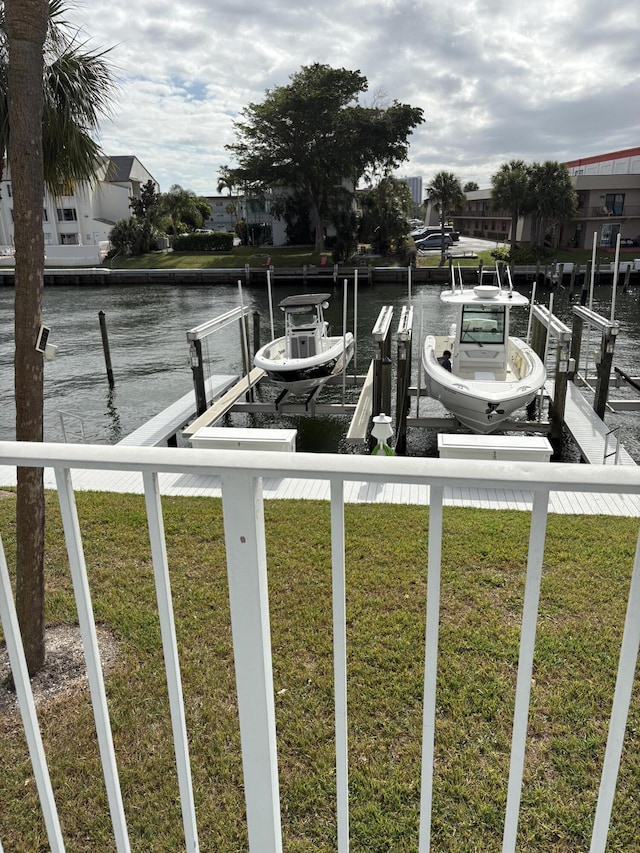 view of dock featuring a lawn