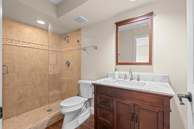 bathroom featuring hardwood / wood-style floors, vanity, toilet, and an enclosed shower