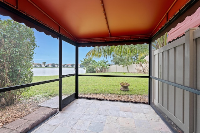 unfurnished sunroom with a water view