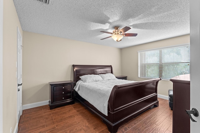 bedroom featuring ceiling fan and dark hardwood / wood-style floors