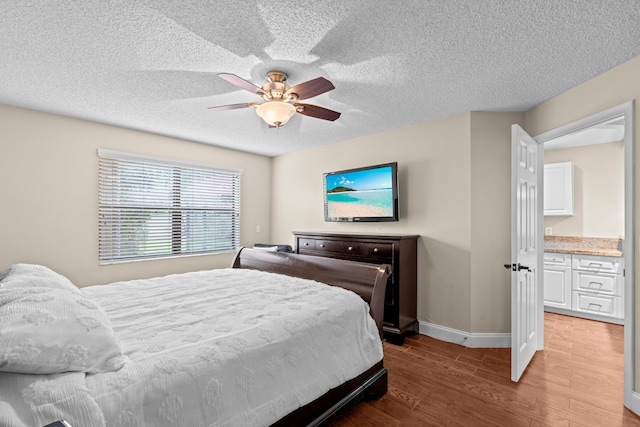 bedroom featuring a textured ceiling, hardwood / wood-style flooring, and ceiling fan